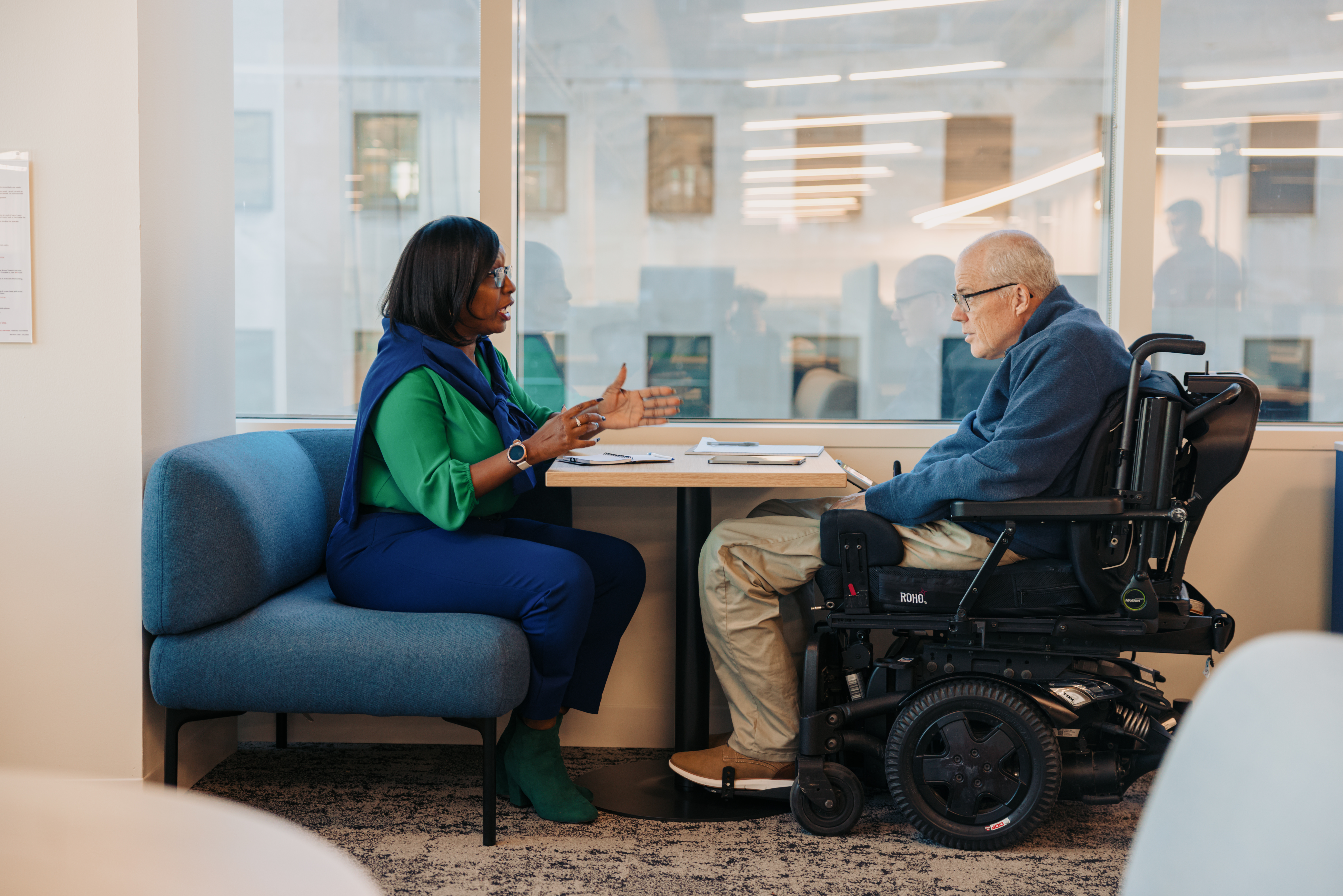 Two colleagues discussing partnership opportunities in a meeting